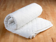 white mattress protection on wooden background