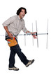 Repairman playing air guitar with a television aerial