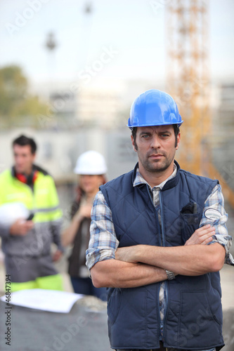 Photo: Foreman stood in front of two colleagues Foreman stood in front of two colleagues