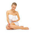 Young smiling girl with body cream