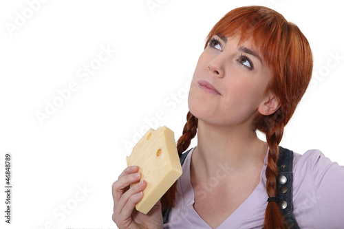 Photo: Woman eating block of cheese Woman eating block of cheese