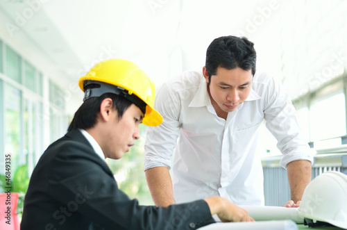 Photo: Two engineers are planning serious Two engineers are planning serious