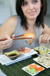 Photo: Brunette eating sushi Brunette eating sushi