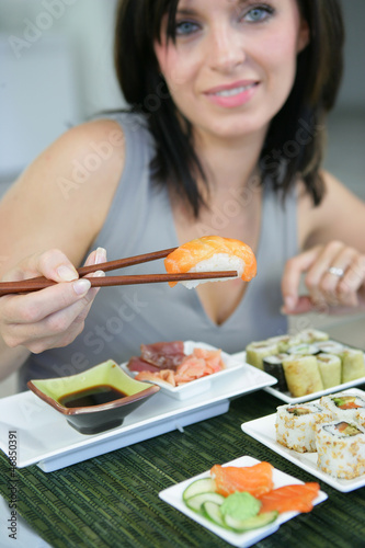 Photo: Brunette eating sushi Brunette eating sushi
