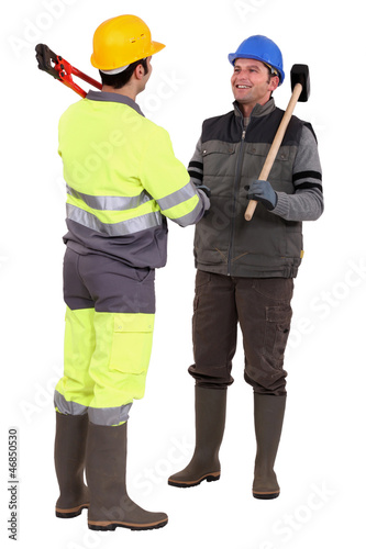 Photo: Tradesmen forming a partnership Tradesmen forming a partnership
