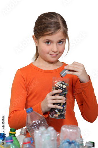 Photo: Girl recycling batteries Girl recycling batteries