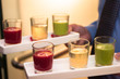 Servers holding colored shot glasses