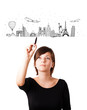 Young woman drawing famous cities and landmarks on whiteboard