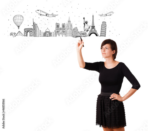 Photo: Young woman drawing famous cities and landmarks on whiteboard Young woman drawing famous cities and landmarks on whiteboard