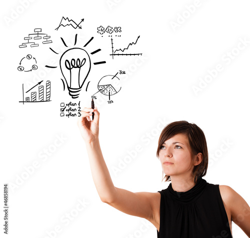 Photo: Young business woman drawing light bulb with various diagrams an Young business woman drawing light bulb with various diagrams an