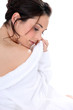 Relaxed brown-haired woman wearing bathrobe