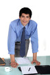 Worker stood by desk
