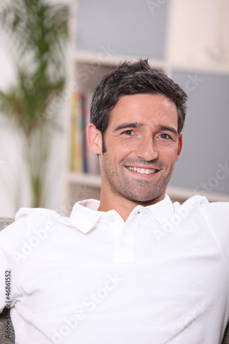 Photo: Portrait of a man relaxing at home Portrait of a man relaxing at home