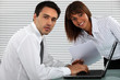 businessman and female colleague working on laptop