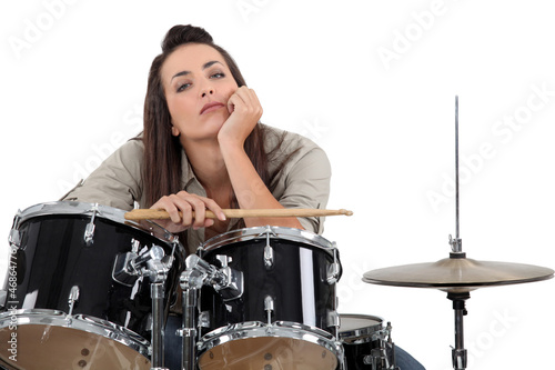 Photo: Woman sat behind drum kit Woman sat behind drum kit
