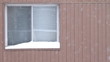 Window of apartment in a winter day. Slowly falling snow