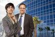 Mixed Race Woman and Businessman in Front of Building