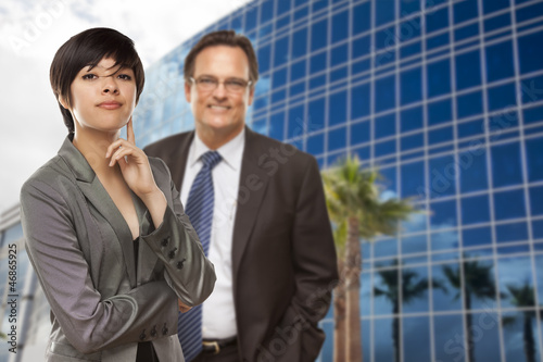 Photo: Mixed Race Woman and Businessman in Front of Building Mixed Race Woman and Businessman in Front of Building