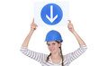Woman holding a road sign