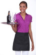 Pretty waitress carrying a beer and two glasses on a tray