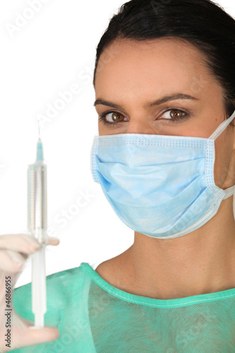 Photo: a doctor going to make an injection a doctor going to make an injection