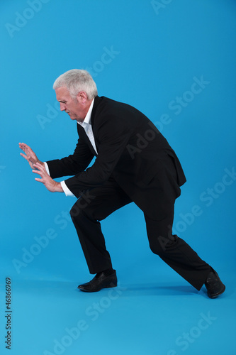 Photo: Businessman pushing against empty copyspace Businessman pushing against empty copyspace