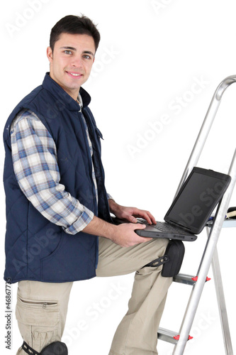 Photo: Tiler stood with ladder and laptop Tiler stood with ladder and laptop