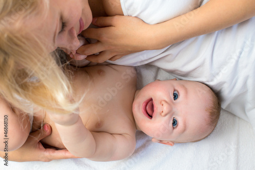 Photo: happy mother lying with baby boy happy mother lying with baby boy