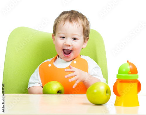 Photo: attractive child eating apples, isolated on white attractive child eating apples, isolated on white