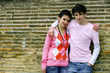 Boy and girl leaning against a wall