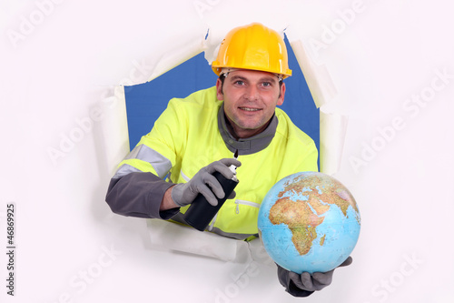 Photo: Man with aerosol and globe Man with aerosol and globe