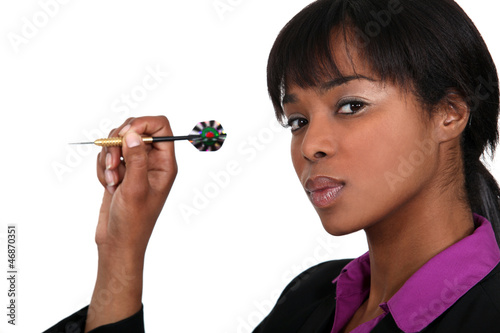 Photo: A businesswoman playing darts. A businesswoman playing darts.