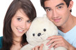 Young man and woman with a teddy bear