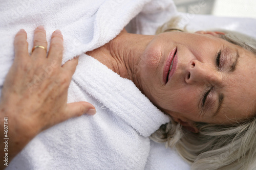 Photo: Elderly lady wearing bathrobe relaxing Elderly lady wearing bathrobe relaxing