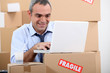 Warehouse manager using laptop