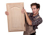 A carpenter holding a closet door.