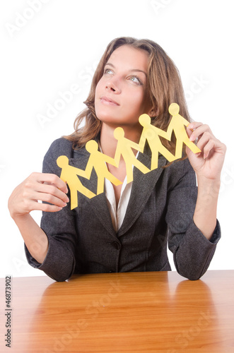 Photo: Businesswoman with paper people on white Businesswoman with paper people on white