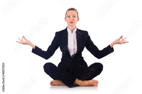 Photo: Young businesswoman meditating on the white Young businesswoman meditating on the white