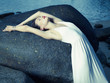 Beautiful elegant lady at huge boulder