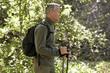 A mature man walking outdoors