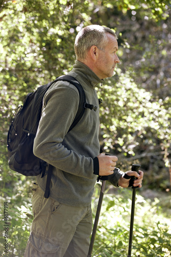 Photo: A mature man walking outdoors A mature man walking outdoors