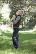 A mature woman holding a pair of binoculars
