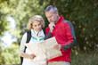 A couple walking in the countryside looking at a map, close up