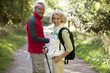 A mature couple standing on a country path smiling, close up