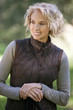 A portrait of a mature woman outdoors, smiling