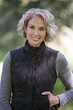 A portrait of a mature woman outdoors, smiling