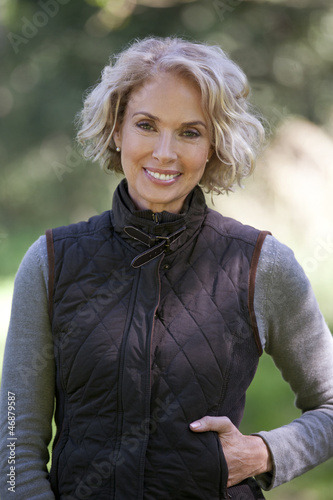 Photo: A portrait of a mature woman outdoors, smiling A portrait of a mature woman outdoors, smiling
