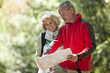 A couple walking in the countryside, looking at a map
