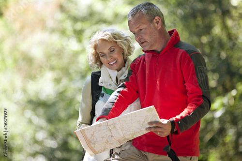 Photo: A couple walking in the countryside, looking at a map A couple walking in the countryside, looking at a map