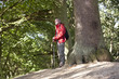 A mature man in the countryside looking at the surrounding view